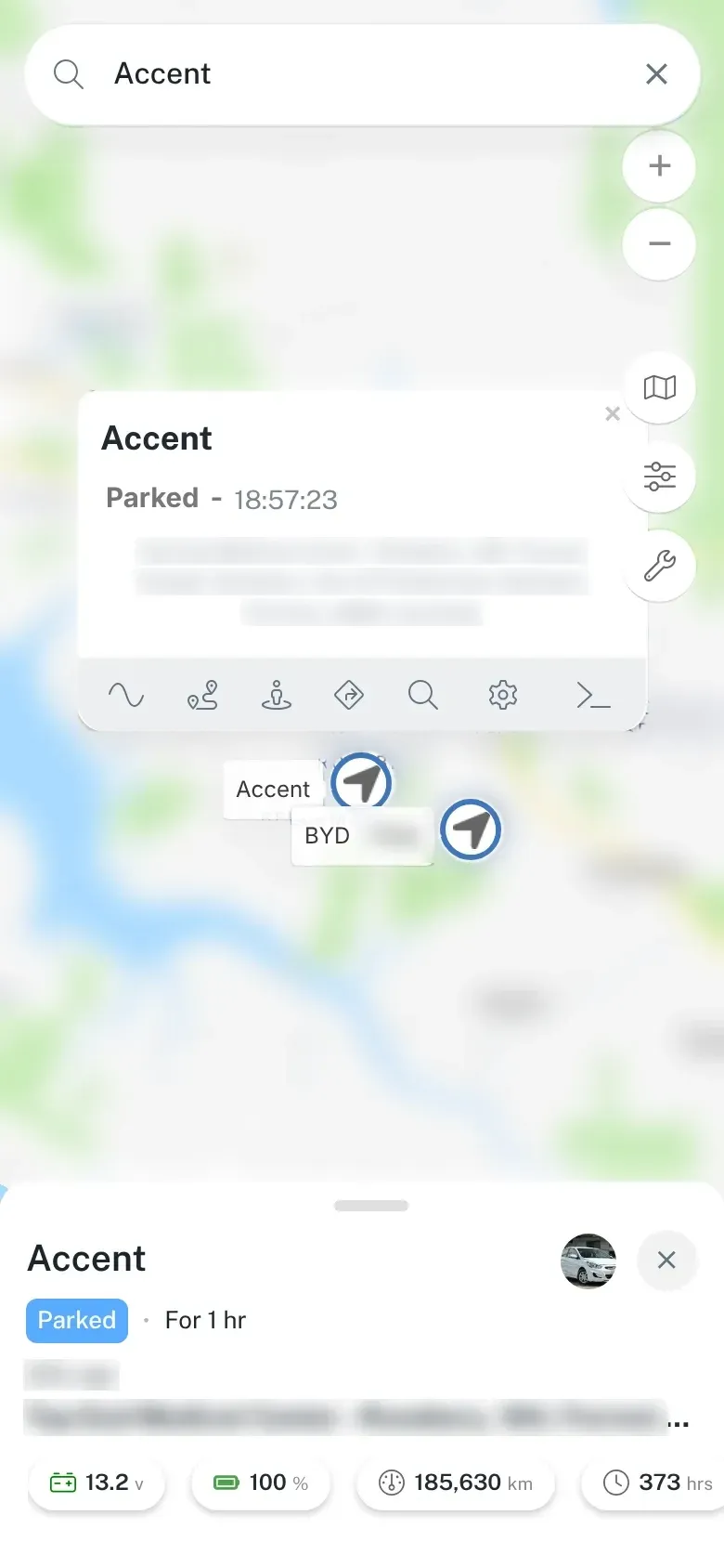 The dashboard on a phone, showing the map with a selected vehicle’s pop-up and, at the bottom, its status, time parked, voltage, battery, odometer and hours. Addresses and map detail are blurred